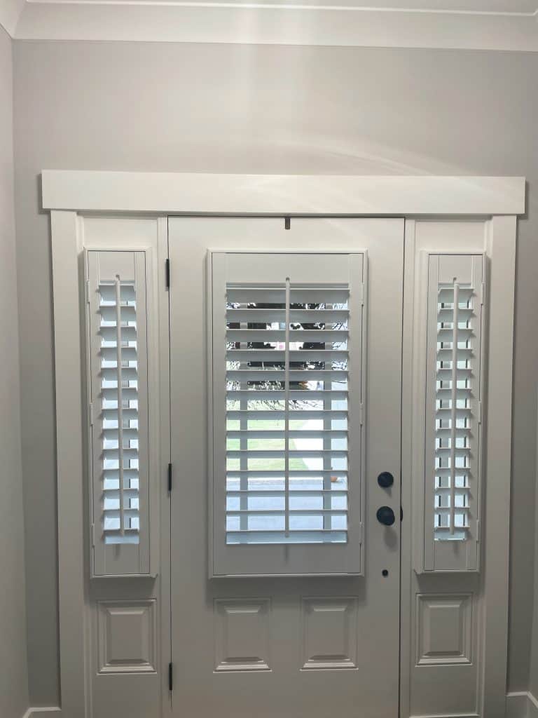 Door and side light plantation shutters painted white with 3.5” louvers, tilt rods, no divider rails , outside mount.