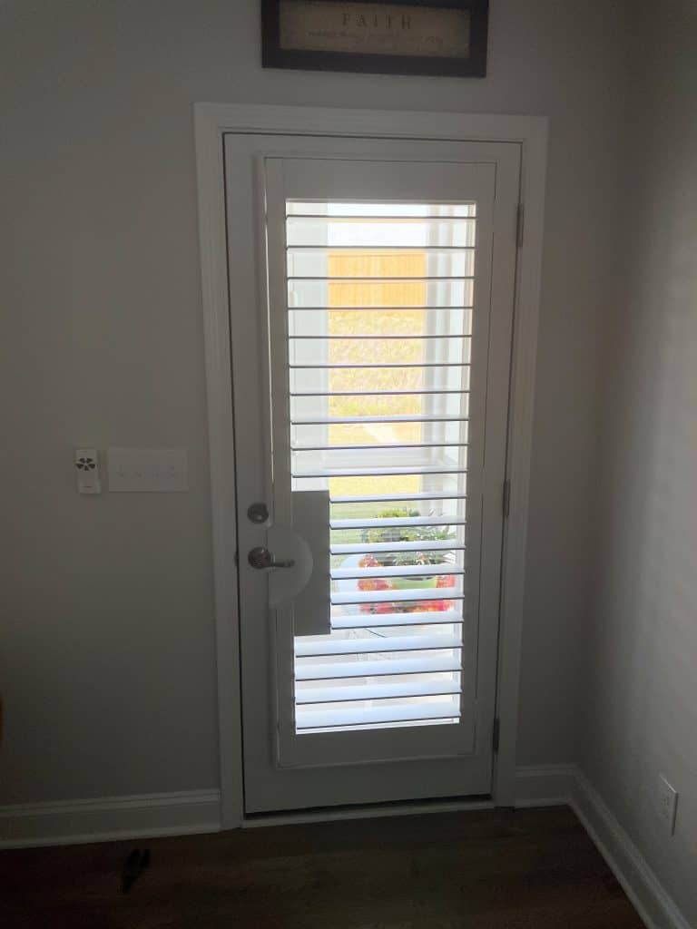 White Painted Wood Shutters With Door Handle Cutout