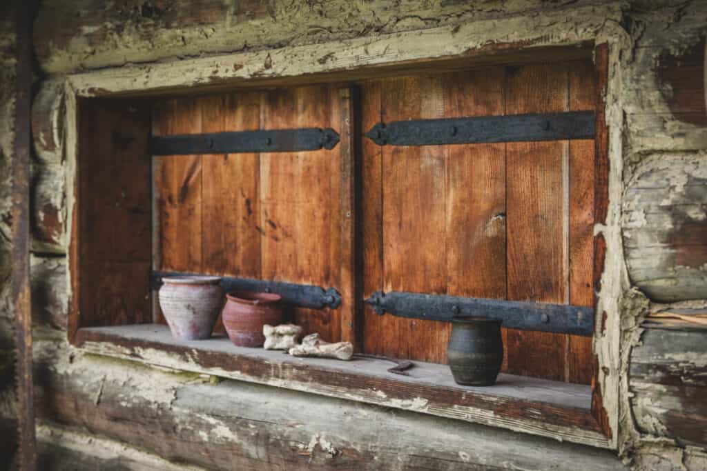 Old historic early medieval house with wooden closed shutters