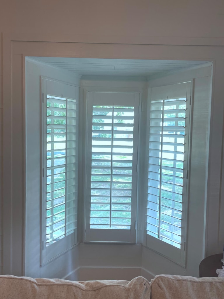 White Painted Plantation Shutters in Living Room Nook Area