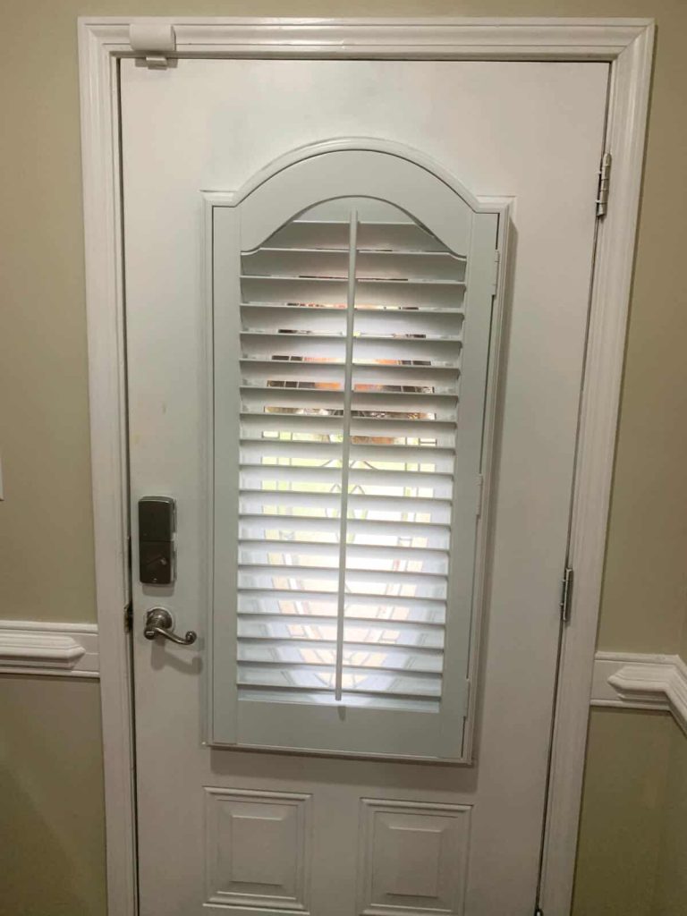 Plantation Shutters on a Door with an Arched Shaped Window